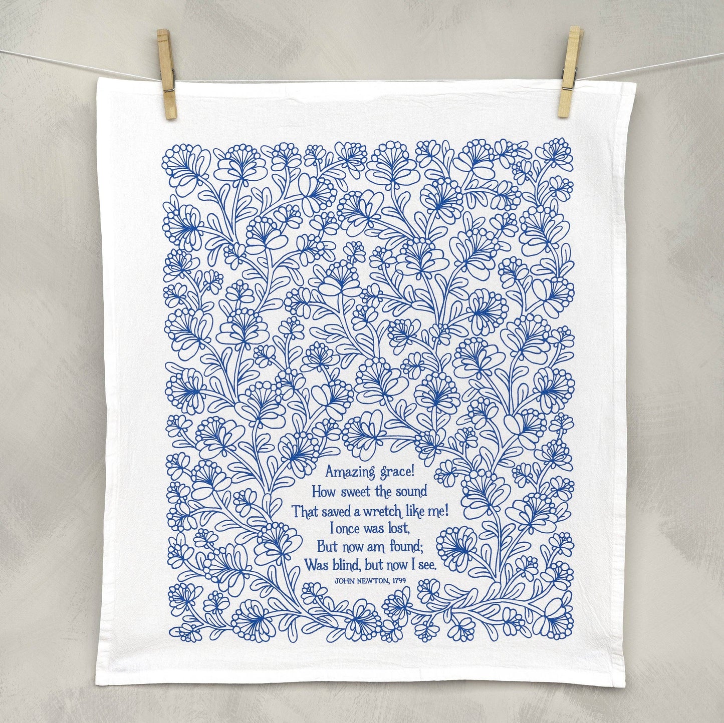 Close-up of hand-lettered Amazing Grace verse on soft white cotton fabric