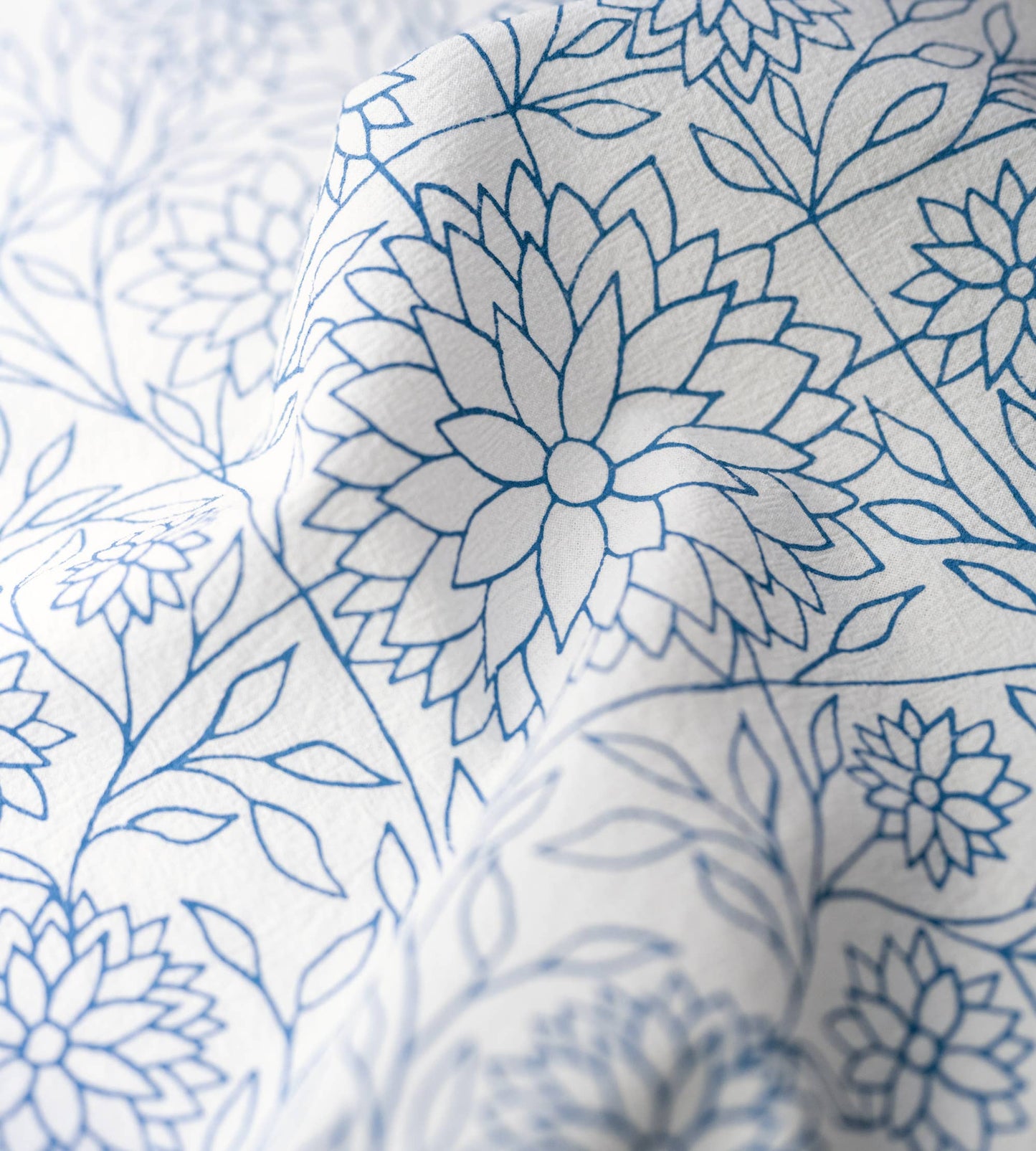 Close-up of delicate florals and hand-lettered verse from Proverbs 31 on soft white cotton fabric