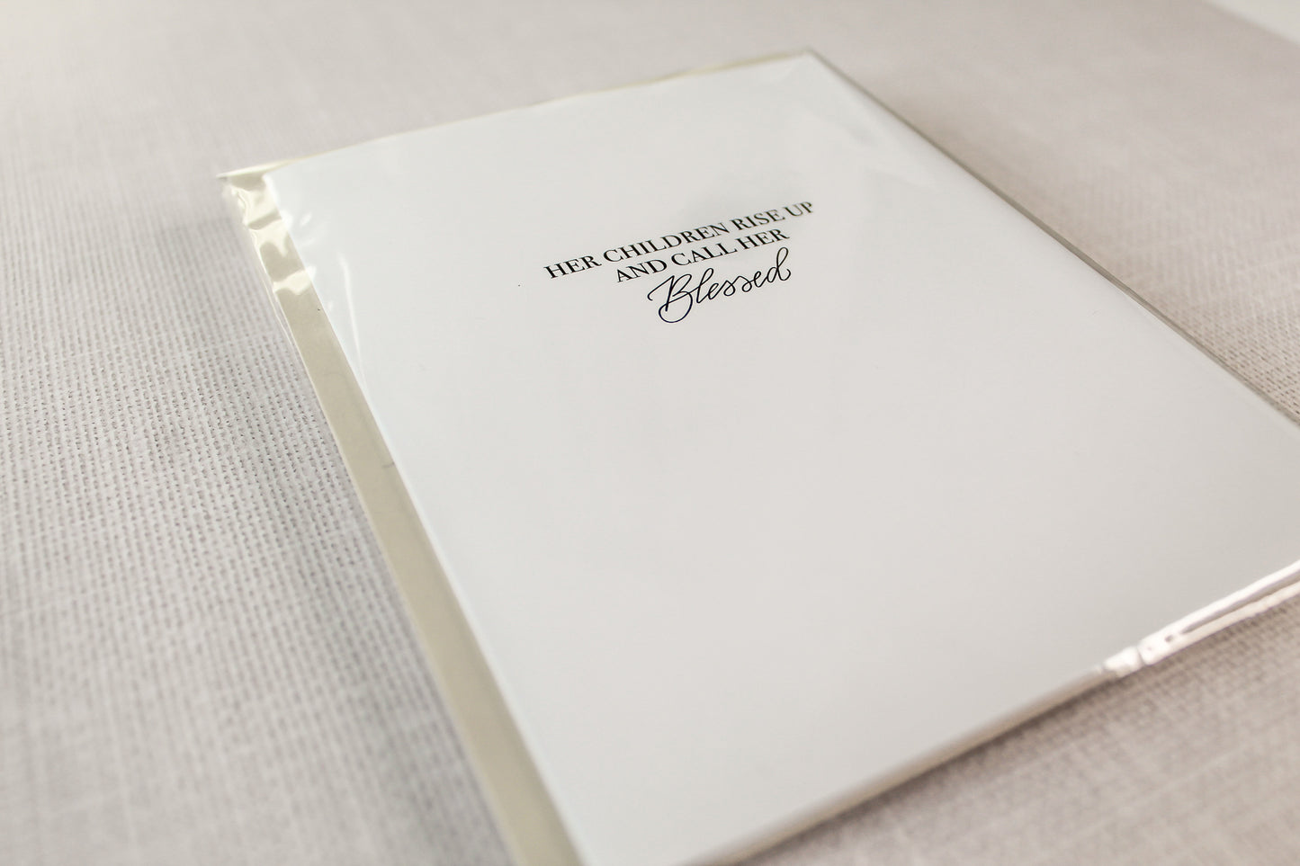 Card reads: "Her Children Rise Up And Call Her Blessed." Each card features digitized hand calligraphy, is printed on a heavy white card stock paper and includes a matching envelope. Cards measure 5.5"x4.25" folded, open horizontally and are blank on the inside.