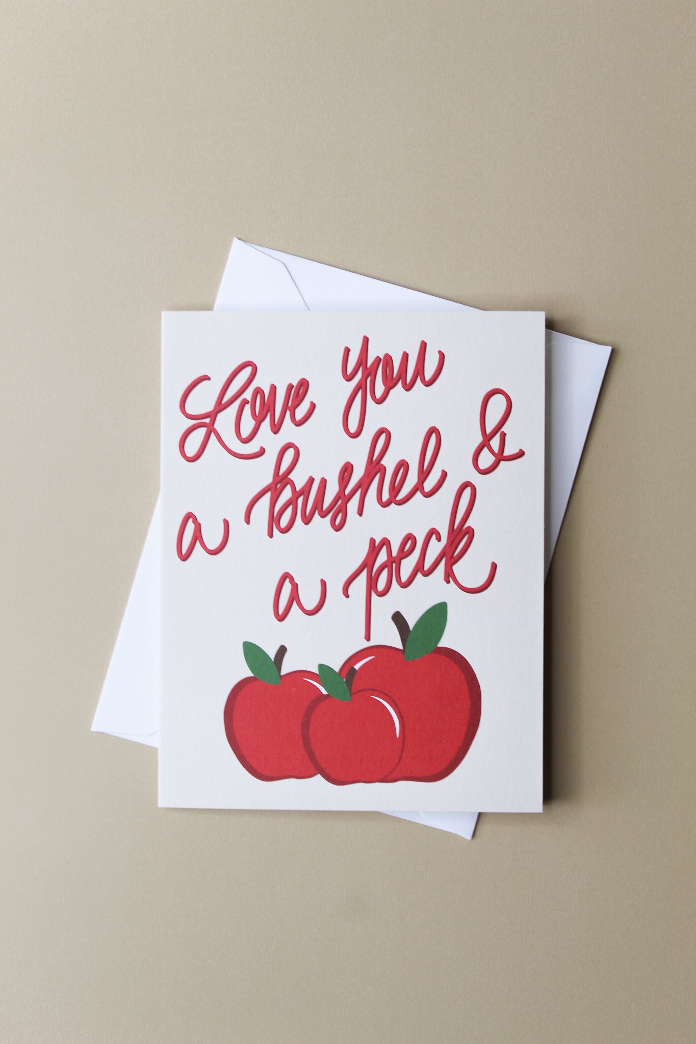 "Love You A Bushel and A Peck" greeting card is part of our cheerful fruit collection and so sweet for a little note of love or thanks to a special friend or child. Each card is folded to 4.25" tall by 5.5" wide, is blank inside and comes with a matching white envelope. Cards are packaged in cellophane sleeves.