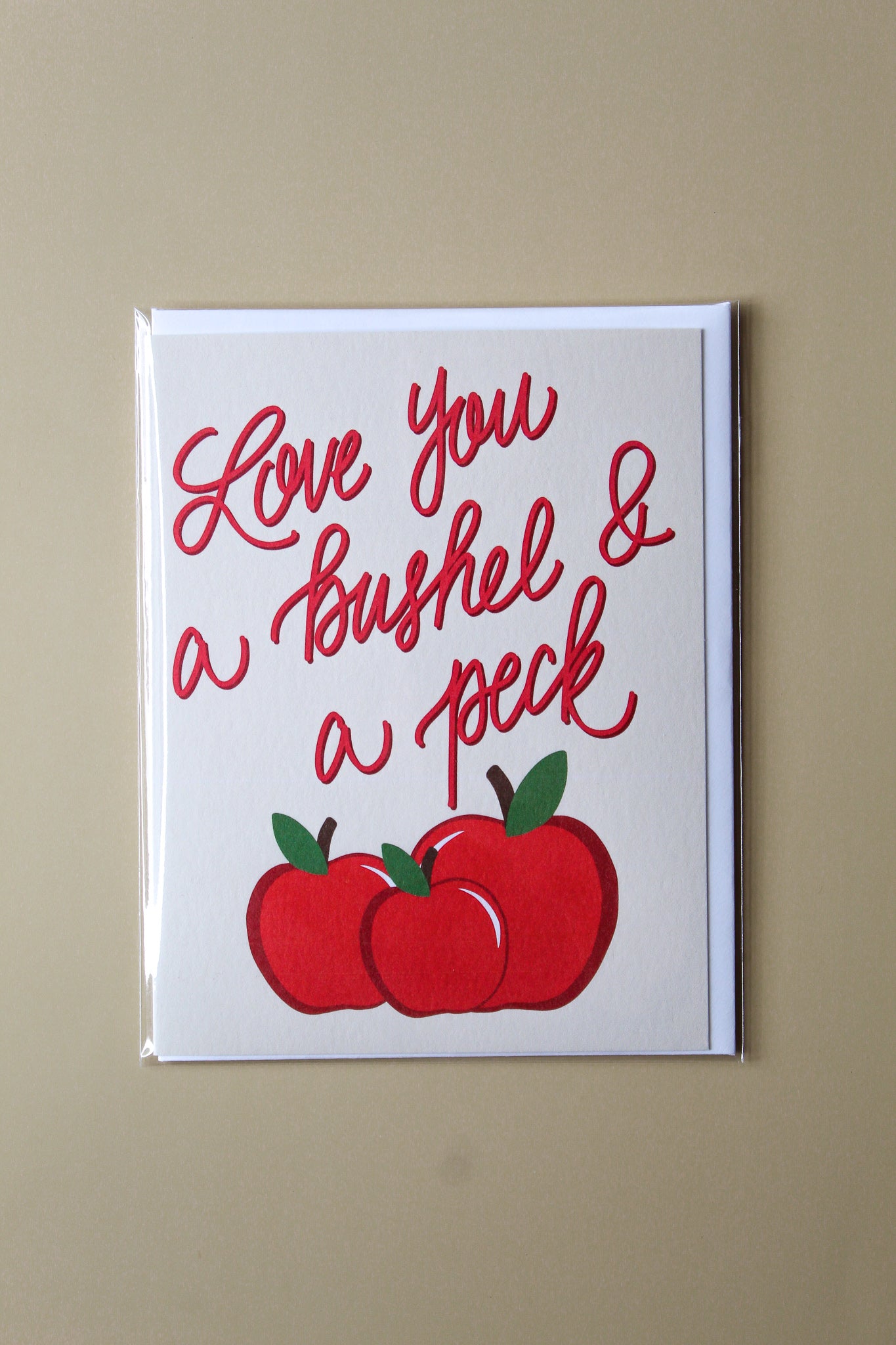 "Love You A Bushel and A Peck" greeting card is part of our cheerful fruit collection and so sweet for a little note of love or thanks to a special friend or child. Each card is folded to 4.25" tall by 5.5" wide, is blank inside and comes with a matching white envelope. Cards are packaged in cellophane sleeves.