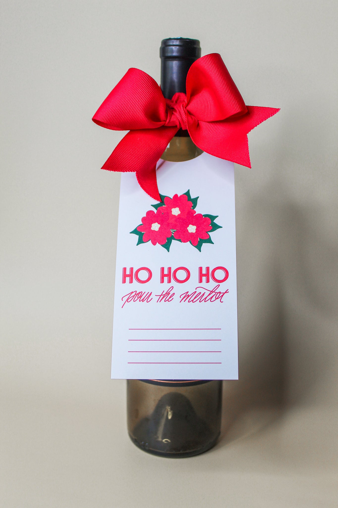 "Ho Ho Ho Pour The Merlot" Holiday Bottle Neck Gift Tags. These tags come complete with pre-cut ribbons, simplifying your gift presentation. Just slide the tag onto the bottle neck, tie the ribbon into a beautiful bow,