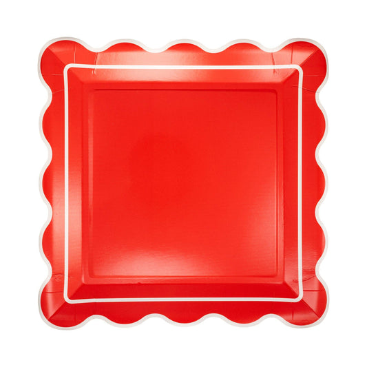 Red square plate with scalloped edge on a white background