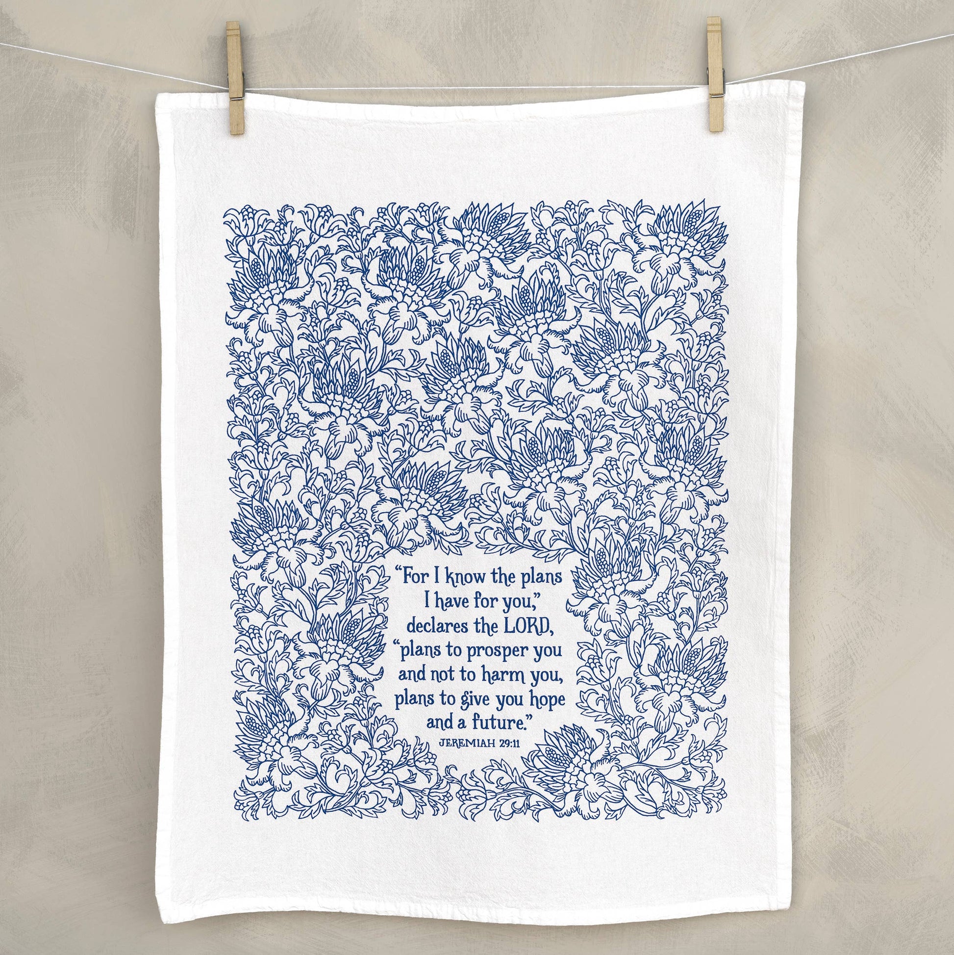 Eco-friendly flour sack towel with faith-based message displayed next to kitchen decor