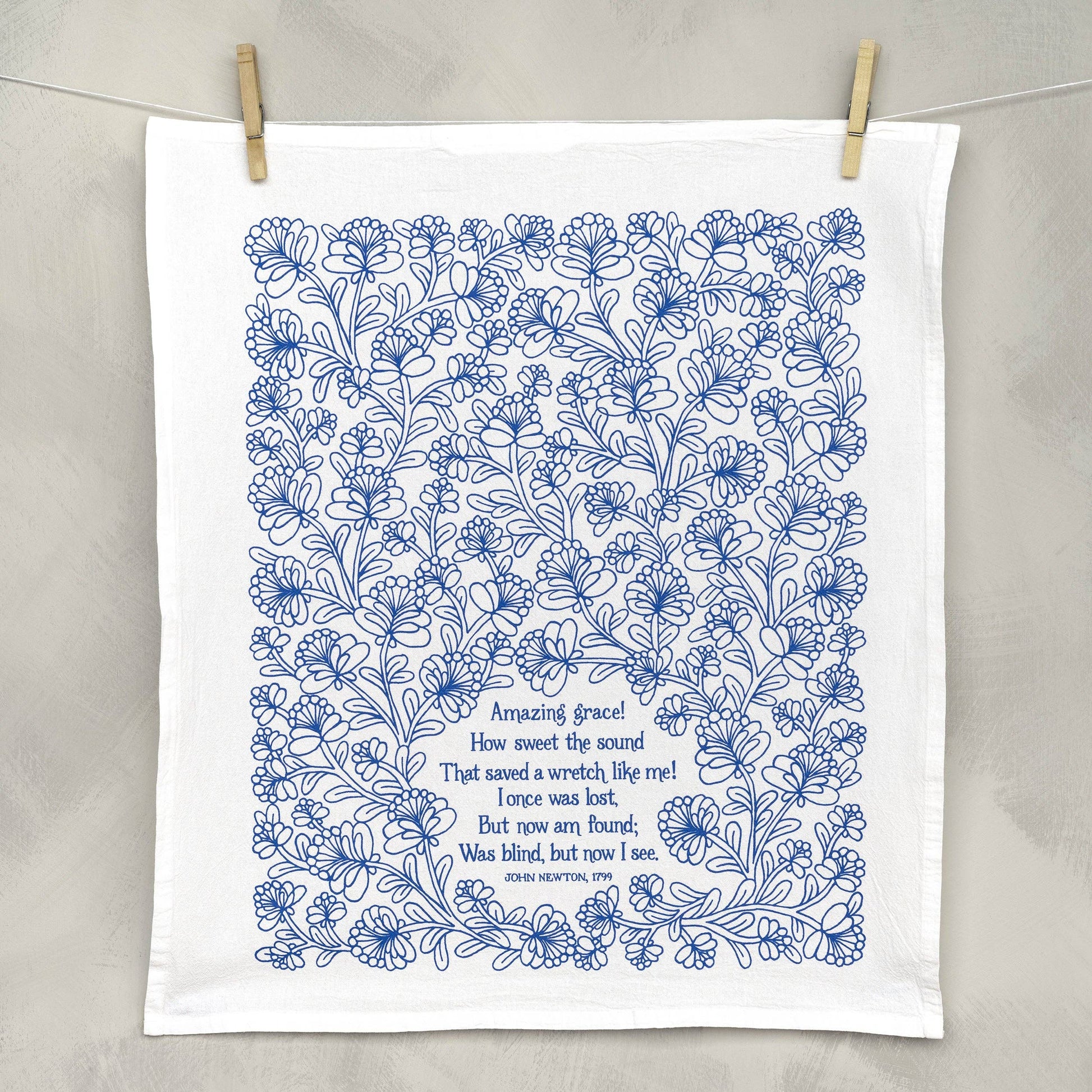 Close-up of hand-lettered Amazing Grace verse on soft white cotton fabric
