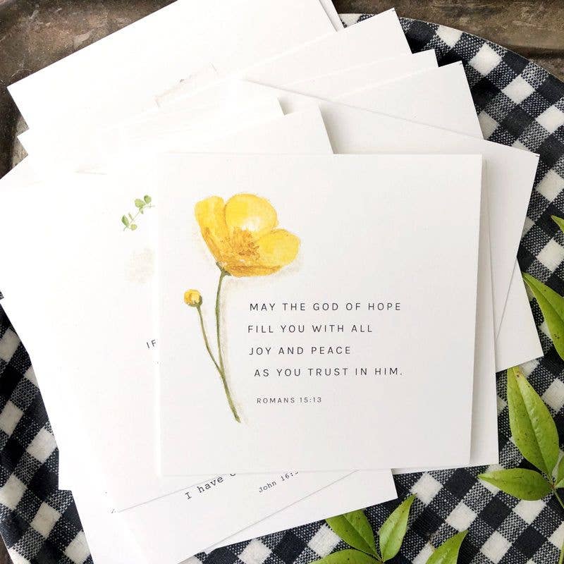 Greeting card with yellow flower illustration and text on a checkered fabric background