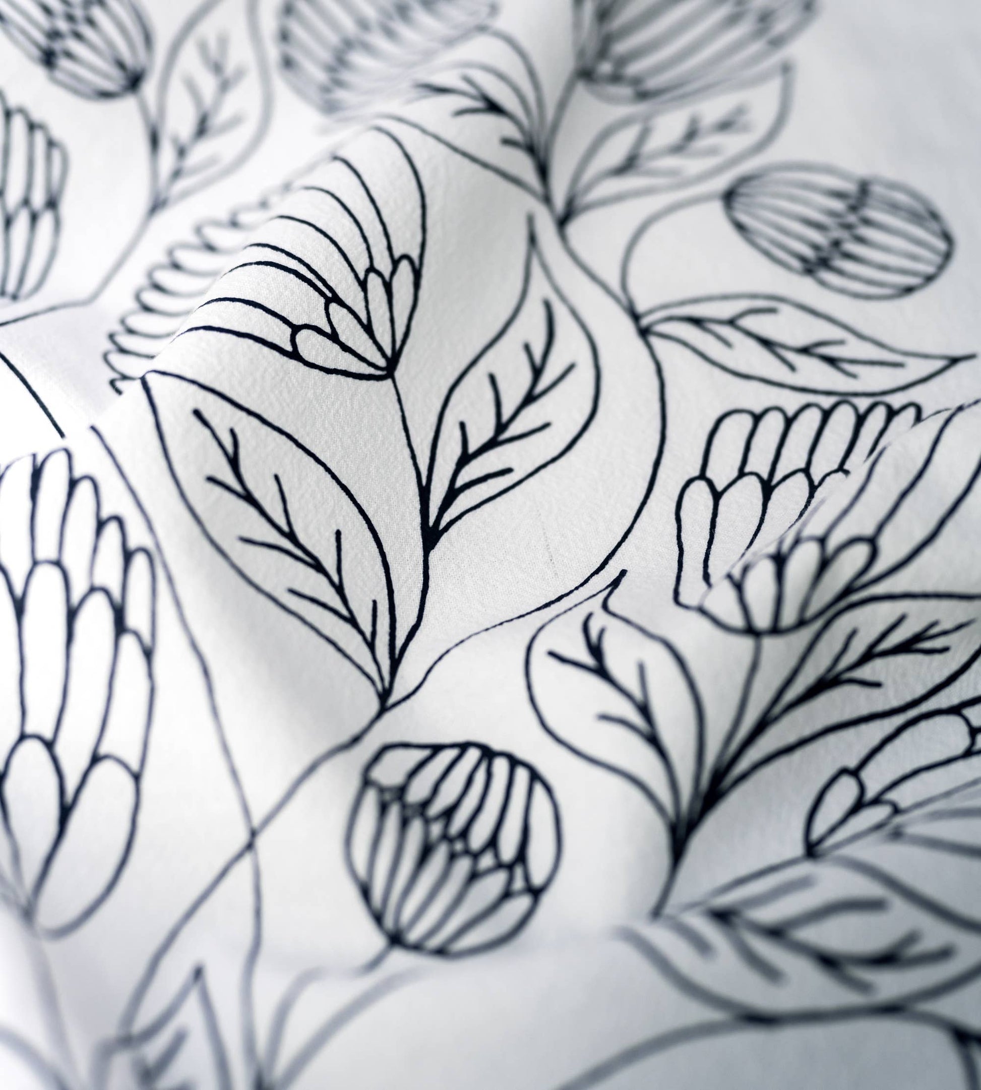 Close-up of florals and hand-lettered Bible verse printed on white cotton fabric