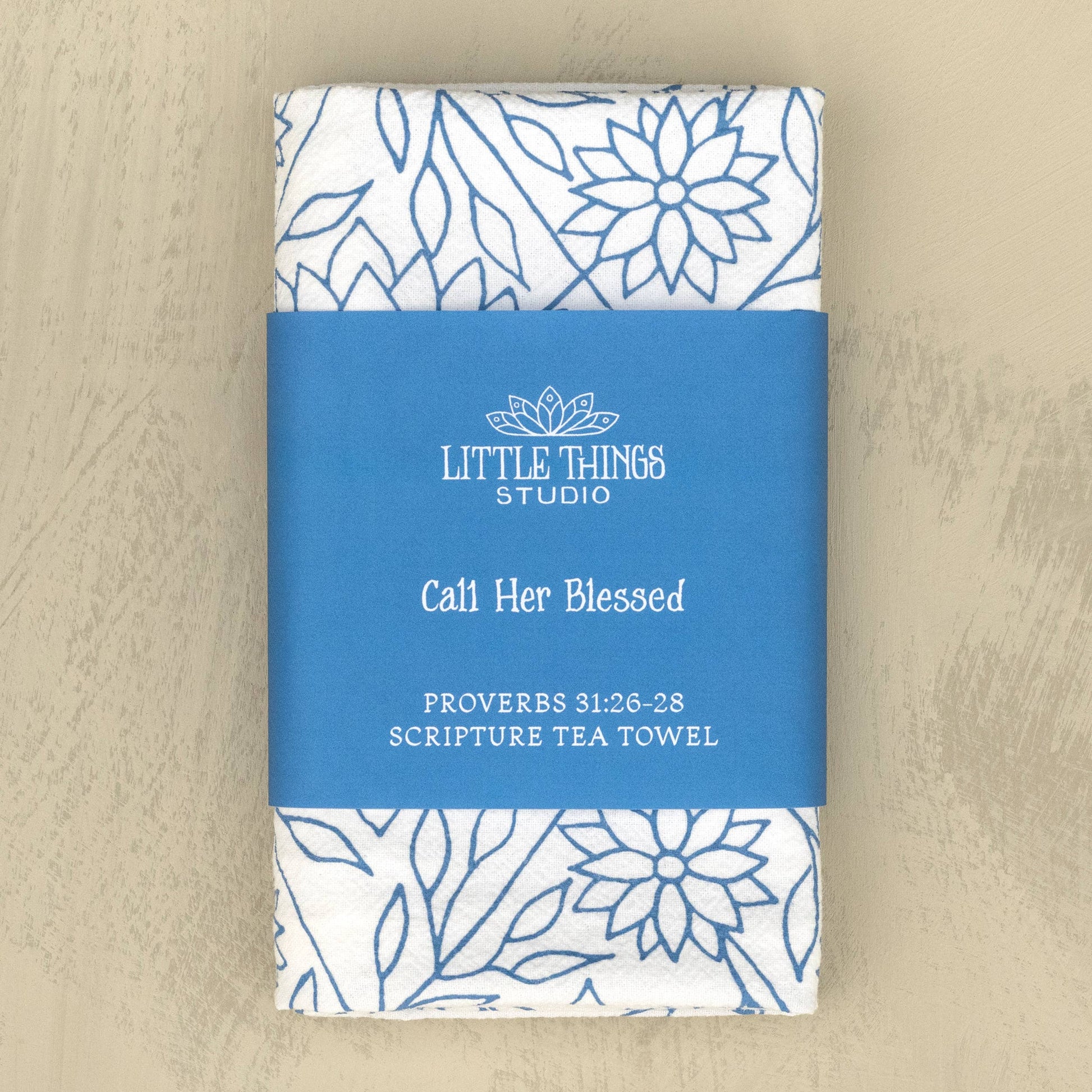 Folded scripture tea towel wrapped in coordinating belly band packaging
