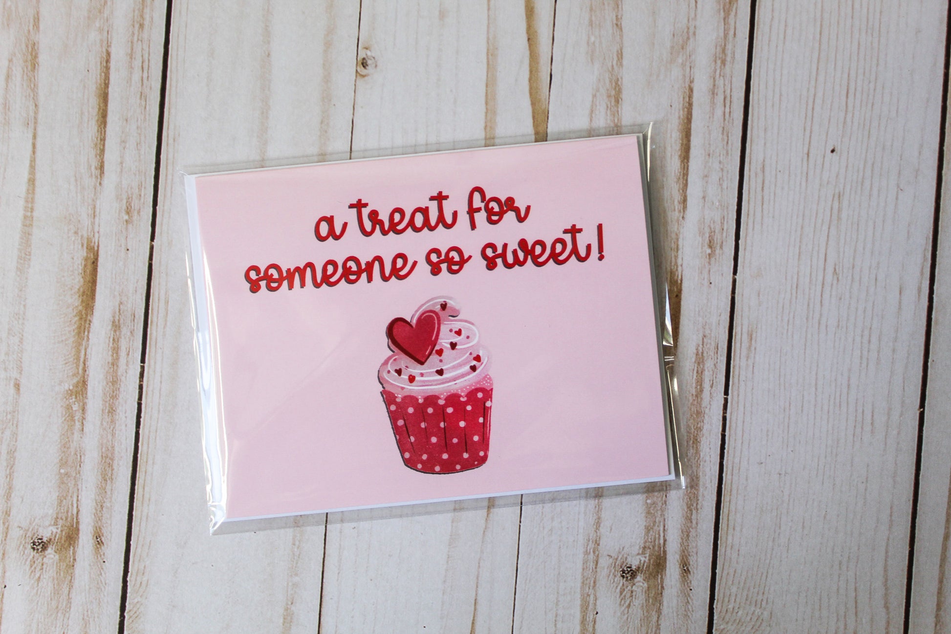 A Treat For Someone So Sweet' card showcases an adorable cupcake design set against a lovely pink background. These cards are meticulously folded to a size of 4.25" in height by 5.5" in width, offering a blank interior, greeting card