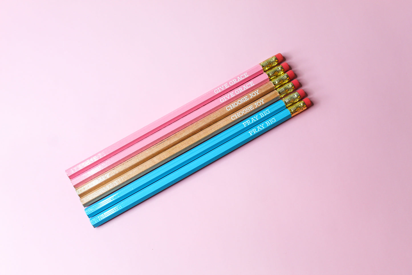 Give Grace, Choose Joy, Pray Big Pencil Set is a hopeful Pencil Set that has six pencils: two pink pencils imprinted with "give grace", two natural wood pencils imprinted with "choose joy" and two blue pencils imprinted with "pray big. 