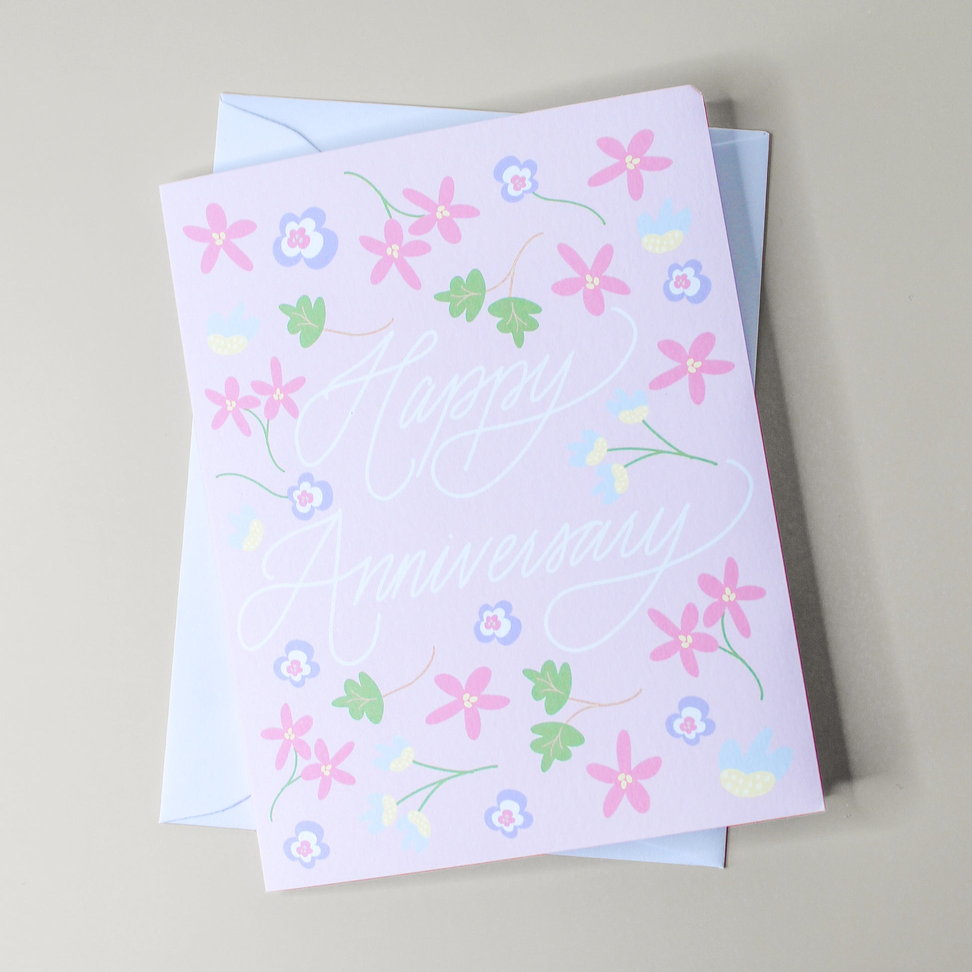 Our "Happy Anniversary" greeting card is too cute! Each card is folded to 4.25" tall by 5.5" wide, is blank inside and comes with a matching white envelope. Cards are packaged in cellophane sleeves.
