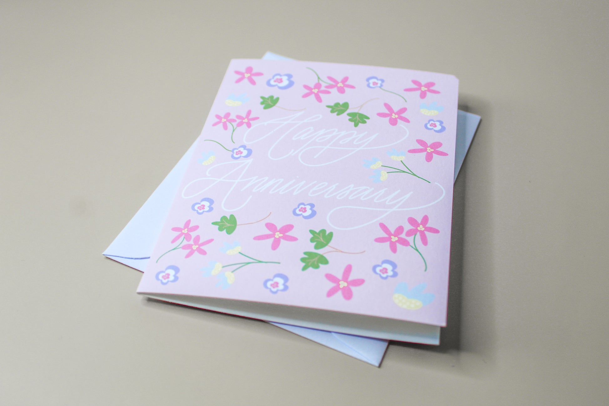 Our "Happy Anniversary" greeting card is too cute! Each card is folded to 4.25" tall by 5.5" wide, is blank inside and comes with a matching white envelope. Cards are packaged in cellophane sleeves.
