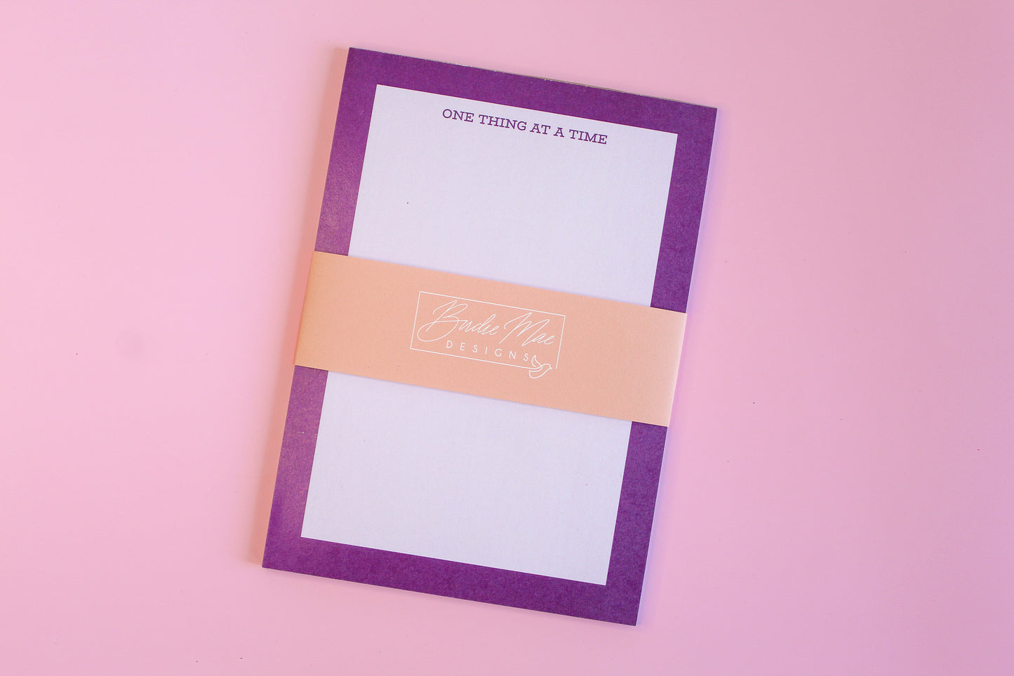 One Thing At A Time' notepads, purple notepad