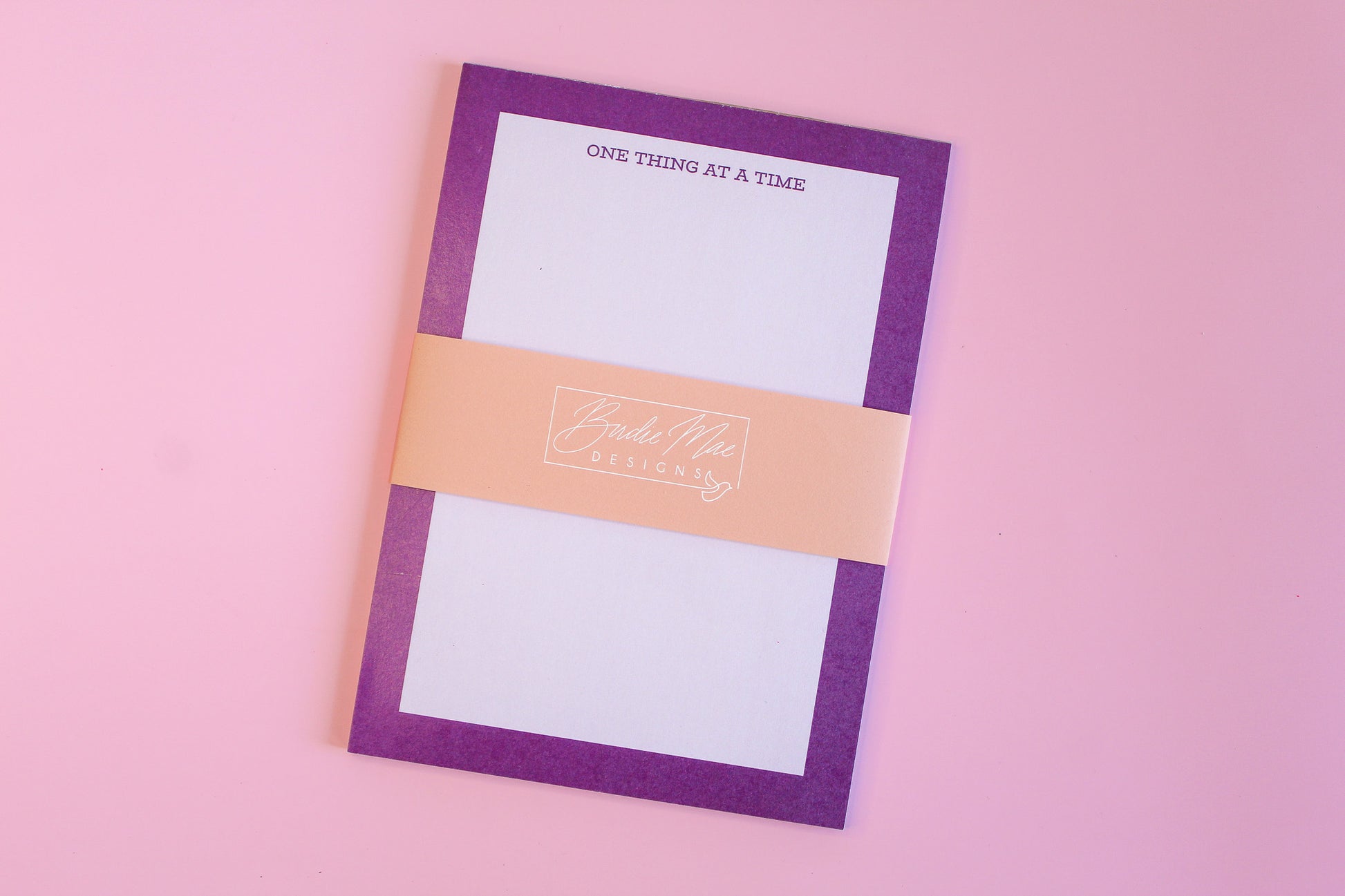One Thing At A Time' notepads, purple notepad