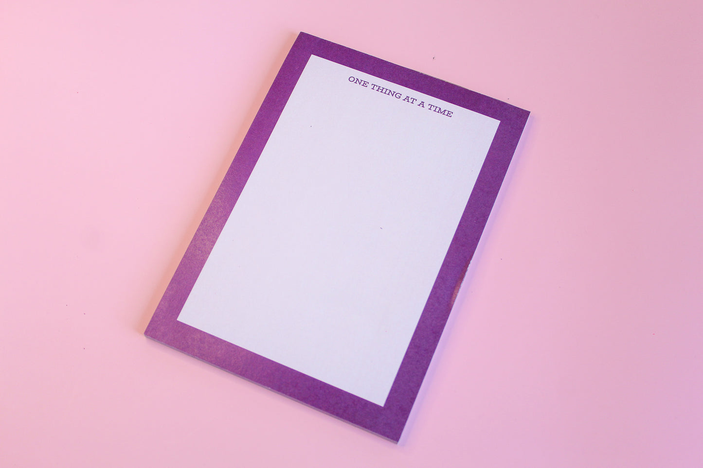 One Thing At A Time' notepads, purple notepad